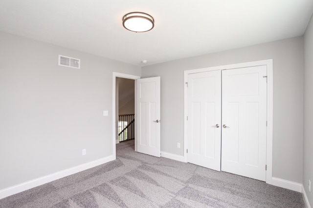 unfurnished bedroom with carpet and a closet