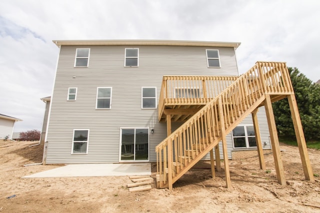 back of house featuring a patio and a deck