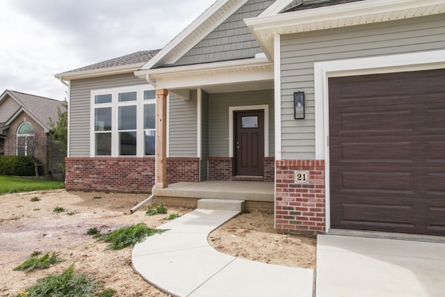 property entrance featuring a garage and covered porch