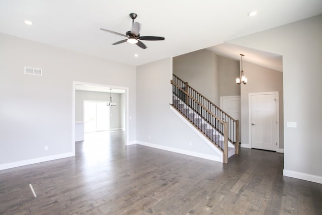 unfurnished living room featuring ceiling fan with notable chandelier, dark hardwood / wood-style floors, and high vaulted ceiling