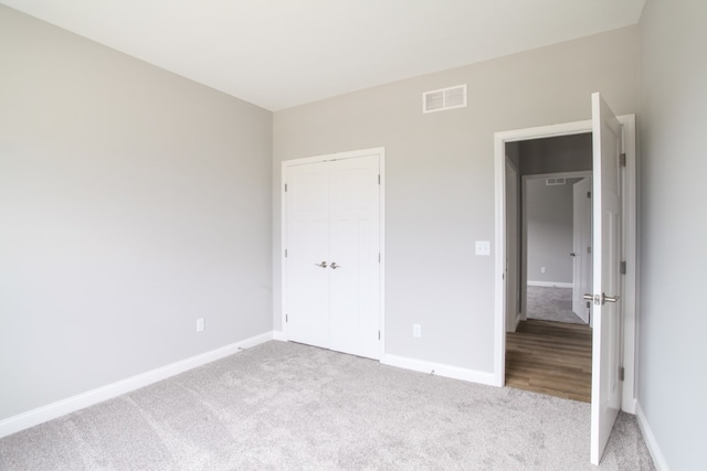 unfurnished bedroom featuring hardwood / wood-style flooring and a closet