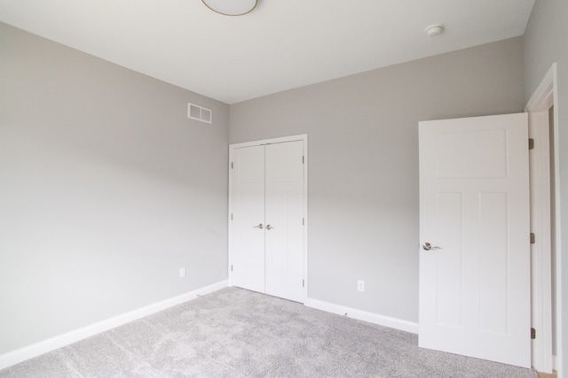 unfurnished bedroom featuring a closet and carpet