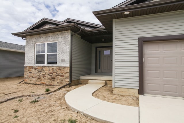 view of exterior entry featuring a garage