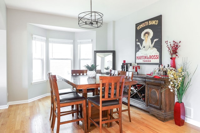 11 N Berkshire Ln, Round Lake, IL 60073 - dining area featuring plenty of natural light, light wood-type flooring, and a chandelier