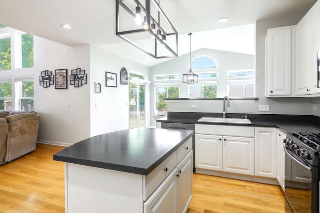 11 N Berkshire Ln, Round Lake, IL 60073 - kitchen with vaulted ceiling, dark countertops, black range with gas stovetop, white cabinetry, and healthy amount of natural light