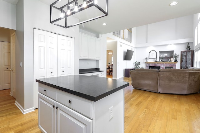 11 N Berkshire Ln, Round Lake, IL 60073 - kitchen featuring dark countertops, light wood-type flooring, white cabinetry, recessed lighting, and open floor plan