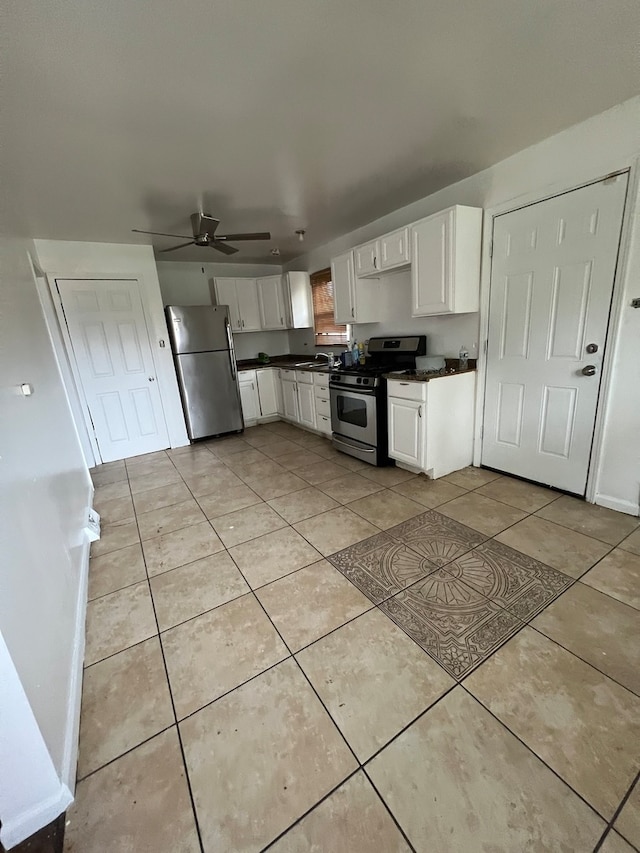 kitchen featuring white cabinets, ceiling fan, stainless steel appliances, and light tile floors