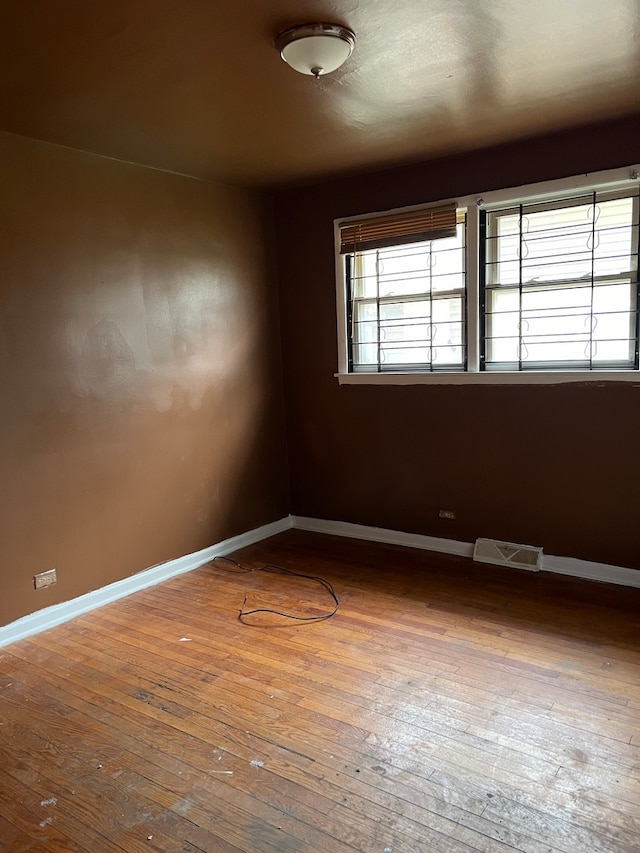 unfurnished room with dark hardwood / wood-style floors