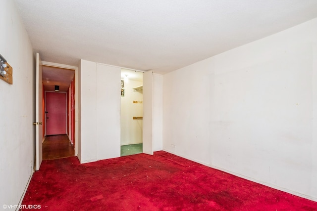 unfurnished bedroom featuring dark colored carpet