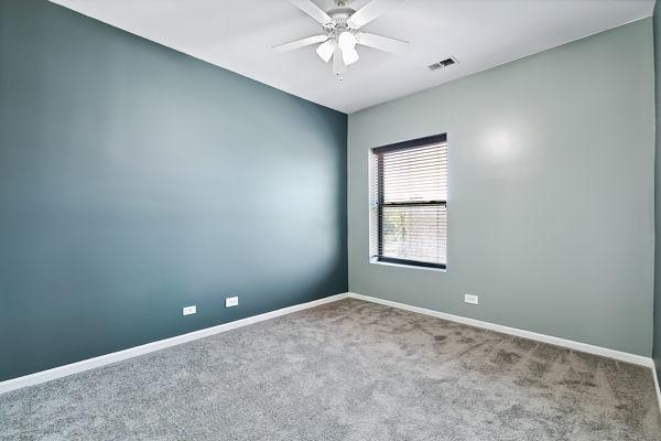 unfurnished room with ceiling fan and carpet flooring