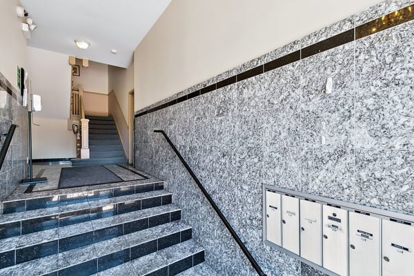 stairs with tile walls and mail boxes