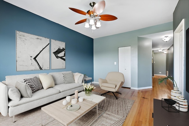 living room featuring hardwood / wood-style flooring and ceiling fan