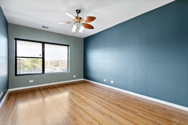 unfurnished room with ceiling fan and light hardwood / wood-style floors