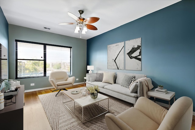 living room featuring light hardwood / wood-style flooring and ceiling fan