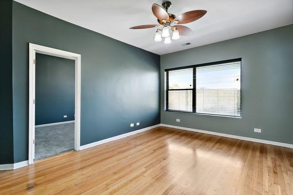 empty room with ceiling fan and light hardwood / wood-style floors