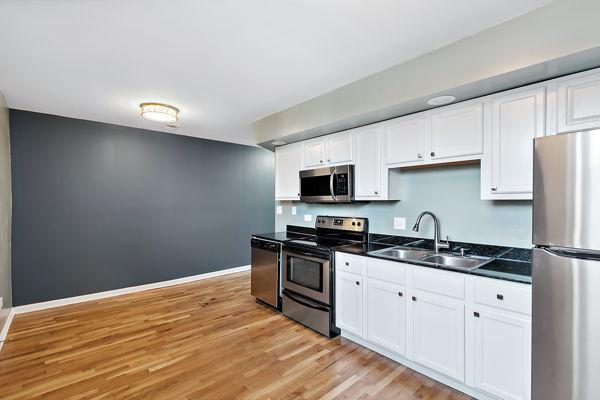 kitchen featuring white cabinetry, appliances with stainless steel finishes, sink, and light hardwood / wood-style flooring