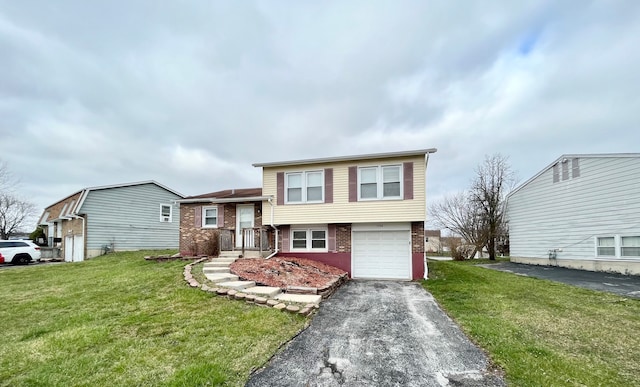 tri-level home featuring a garage and a front lawn