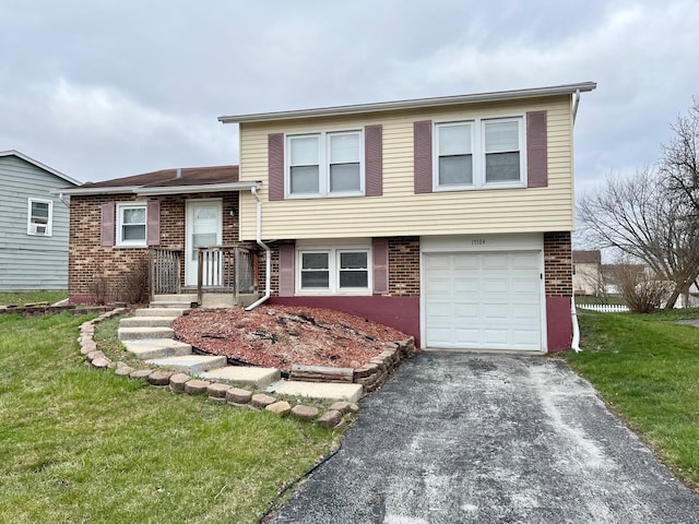 split level home with a garage and a front lawn