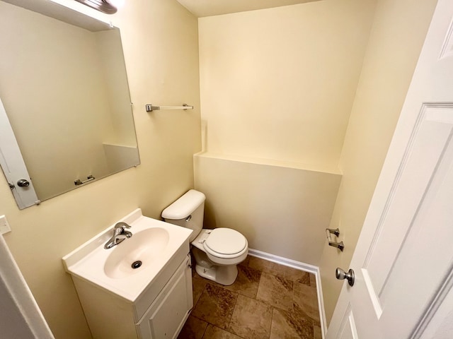 bathroom featuring vanity, toilet, and tile floors