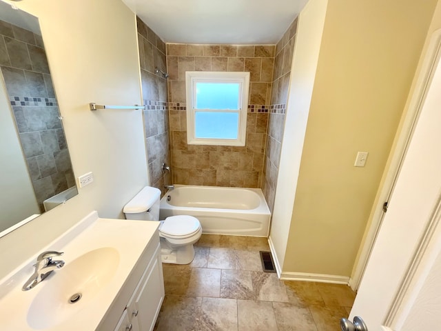 full bathroom with vanity with extensive cabinet space, toilet, tile flooring, and tiled shower / bath combo