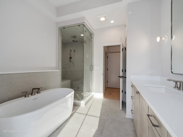 bathroom featuring vanity, shower with separate bathtub, and tile patterned flooring