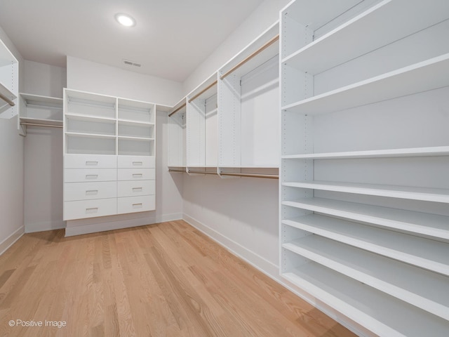 walk in closet featuring light hardwood / wood-style floors