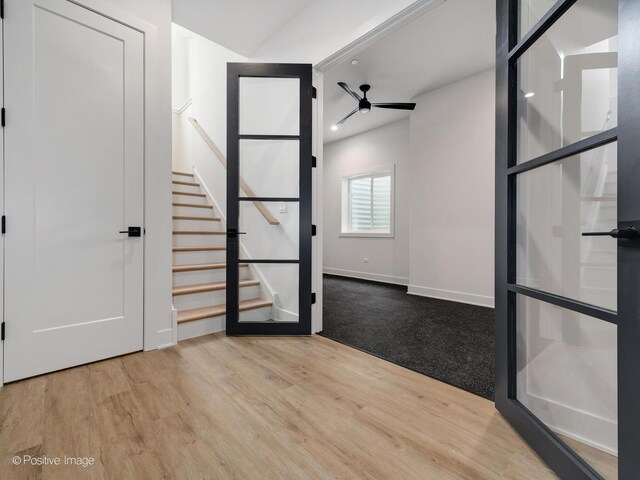 interior space featuring ceiling fan and light wood-type flooring