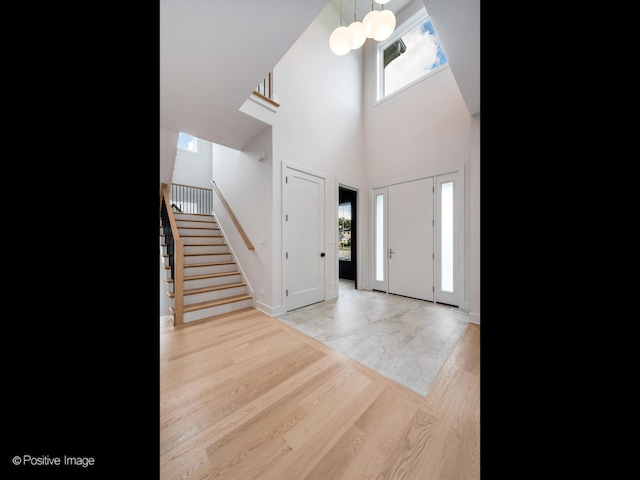 entrance foyer featuring a high ceiling and light hardwood / wood-style floors