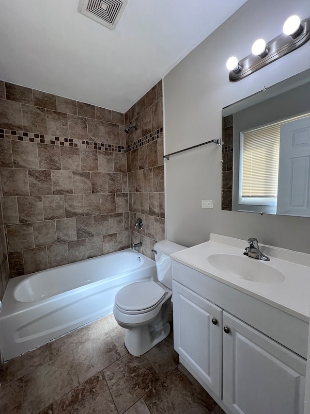 full bathroom featuring tiled shower / bath combo, large vanity, toilet, and tile flooring