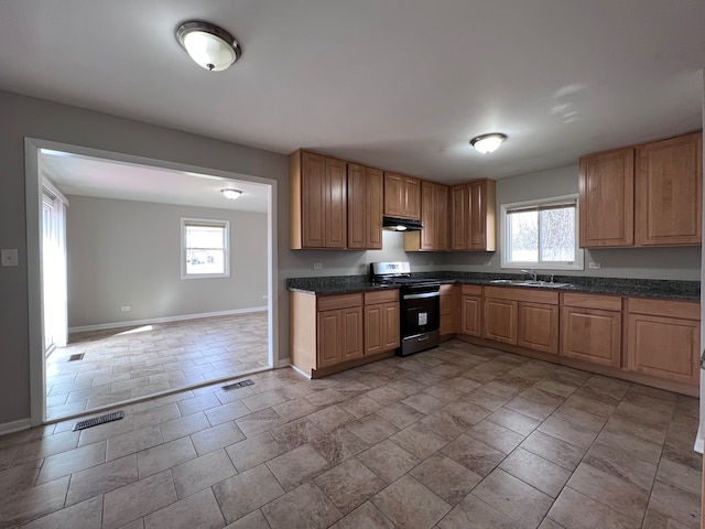 kitchen with a healthy amount of sunlight, black electric range oven, and tile flooring