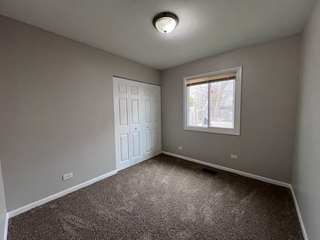 unfurnished bedroom with carpet and a closet