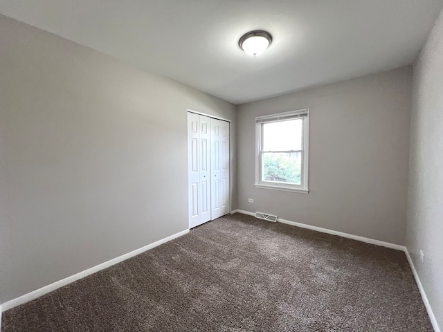 unfurnished bedroom with a closet and carpet flooring