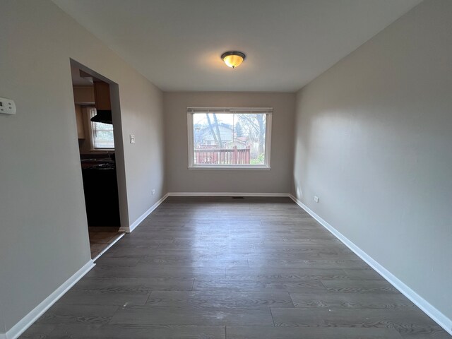 empty room with dark hardwood / wood-style floors