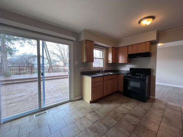 kitchen featuring sink, black stove, and light tile flooring