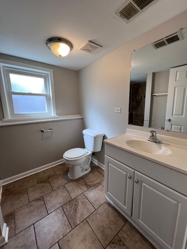 bathroom with tile flooring, vanity, and toilet