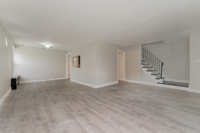 unfurnished living room with light wood-type flooring