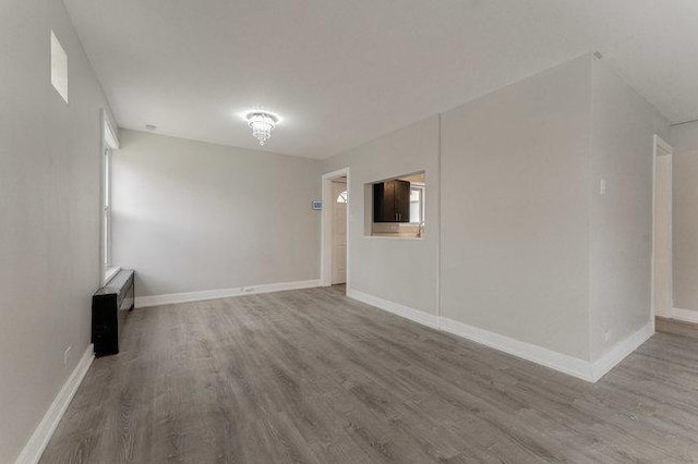 unfurnished room featuring wood finished floors and baseboards