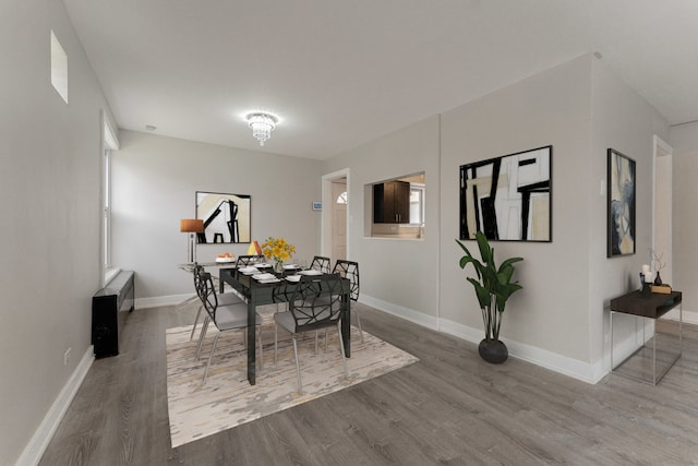 kitchen with light wood-type flooring, baseboards, light countertops, and a sink