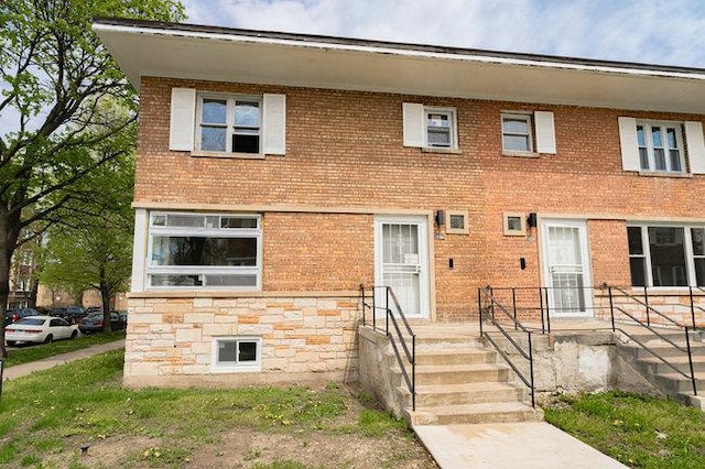 view of property with stone siding and brick siding