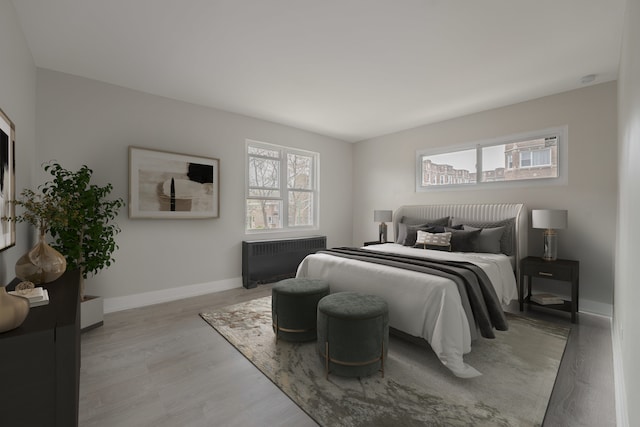 unfurnished living room featuring wood finished floors and baseboards