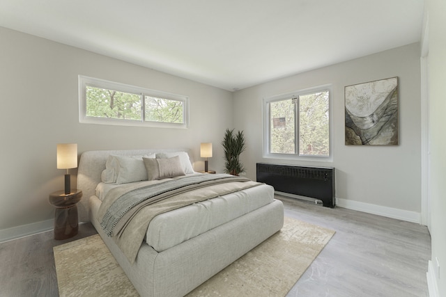 empty room featuring light wood-style floors, stairs, and baseboards