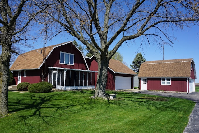 view of front of property with a front lawn and a garage