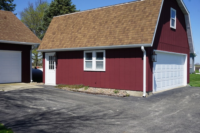 view of property exterior featuring a garage and an outdoor structure