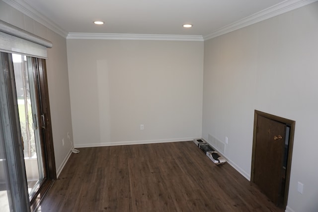 empty room featuring ornamental molding and dark hardwood / wood-style floors