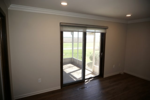 empty room with ornamental molding and dark hardwood / wood-style flooring