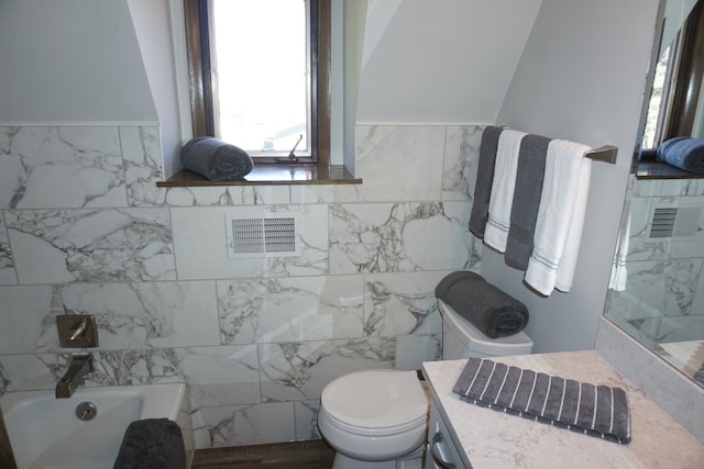 bathroom with tile walls, toilet, and a bathing tub