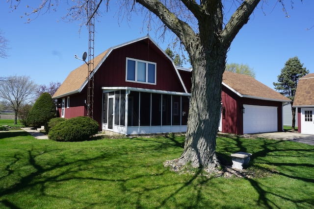 view of front facade featuring a front yard, a garage, and a sunroom