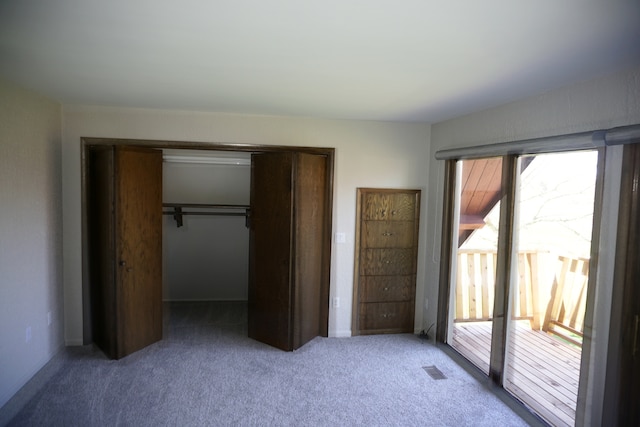 unfurnished bedroom featuring a closet and dark colored carpet