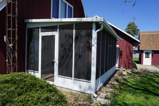 view of side of home with a sunroom