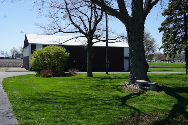 exterior space featuring a garage and a lawn